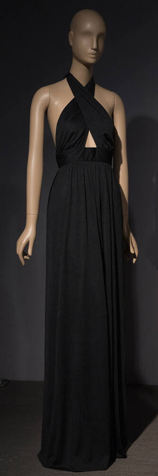 Black floor length evening gown with crisscrossing halter neck creating small midriff cutout 
