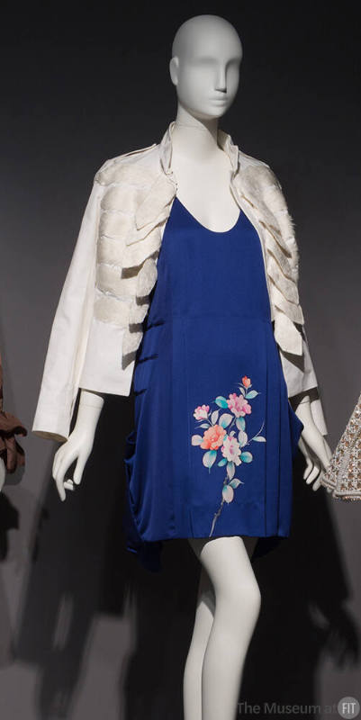 Royal blue mini dress with multicolor flowers on skirt and white stand collar jacket with rows …