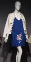 Royal blue mini dress with multicolor flowers on skirt and white stand collar jacket with rows …