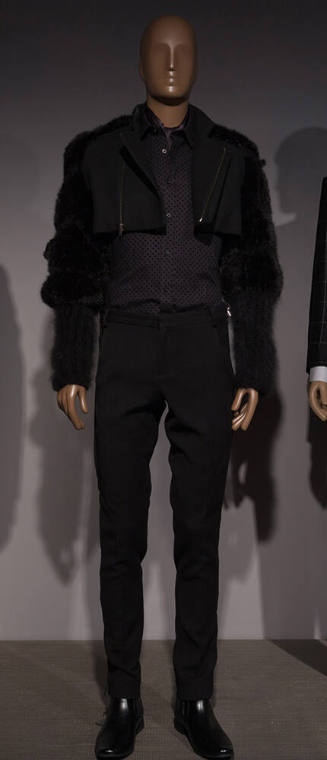 Man’s black ensemble of bolero jacket with fur sleeves, polka dot button front shirt, slim pant…