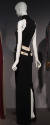 Back view of sleeveless floor length black dress with off-white waist band and pocket flaps wit…