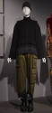 Alternate view of black vest and green cargo pants ensemble on exhibition platform 