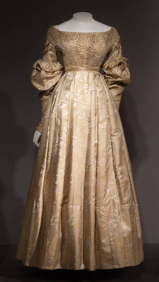 Gold and white silk floral dress with smocked bodice, wide neck, long puffed sleeves, floor-len…