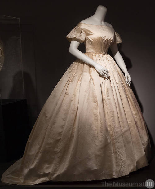 Cream silk wedding dress with wide neck bodice, short flared sleeves, fitted waist and very ful…