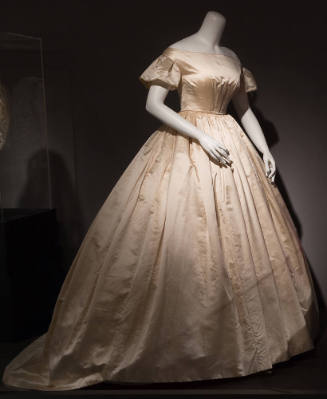Cream silk wedding dress with wide neck bodice, short flared sleeves, fitted waist and very ful…
