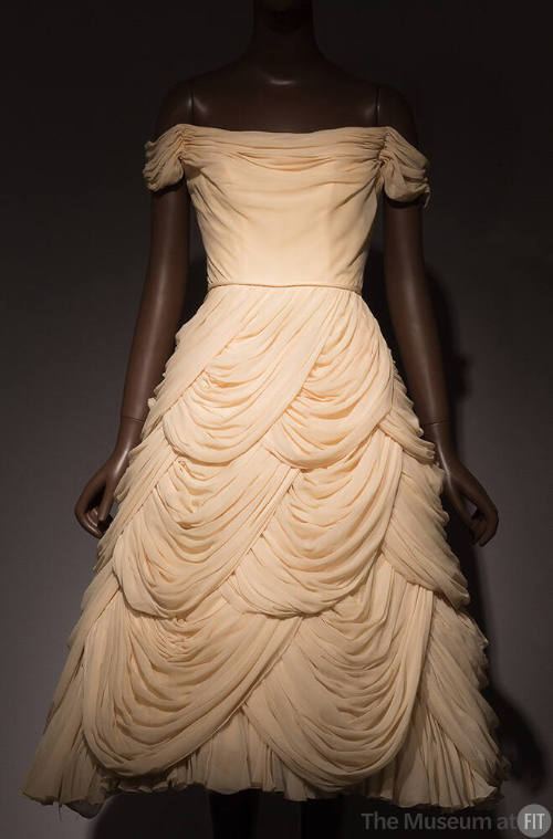 Ivory strapless cocktail dress with draped cowl neck, off the shoulder sleeves and multiple tie…