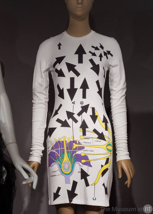White long sleeve mini dress with allover printed black arrows and purple, lavender, aqua and y…