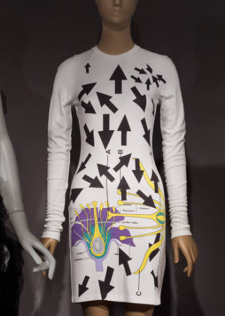White long sleeve mini dress with allover printed black arrows and purple, lavender, aqua and y…