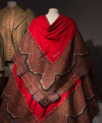 Back view of paisley shawl with embroidered borders in red, green, blue, black, orange, and whi…