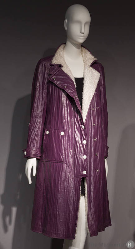 Purple crinkled knee length coat with notched lapels, white button closure, front patch pocket …