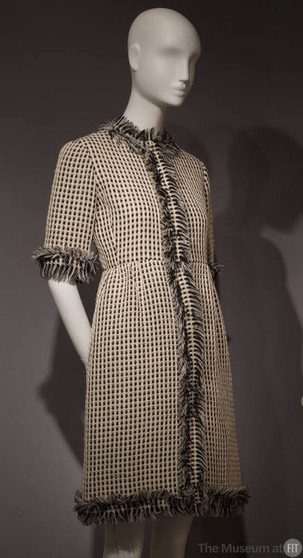 Black and white woven dress with self fringe trim around neckline and sleeve cuff